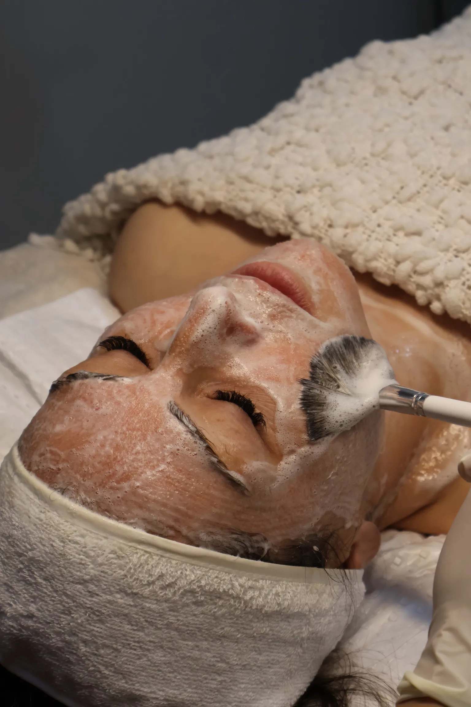 Professional facial mask application at Beauty Atelier