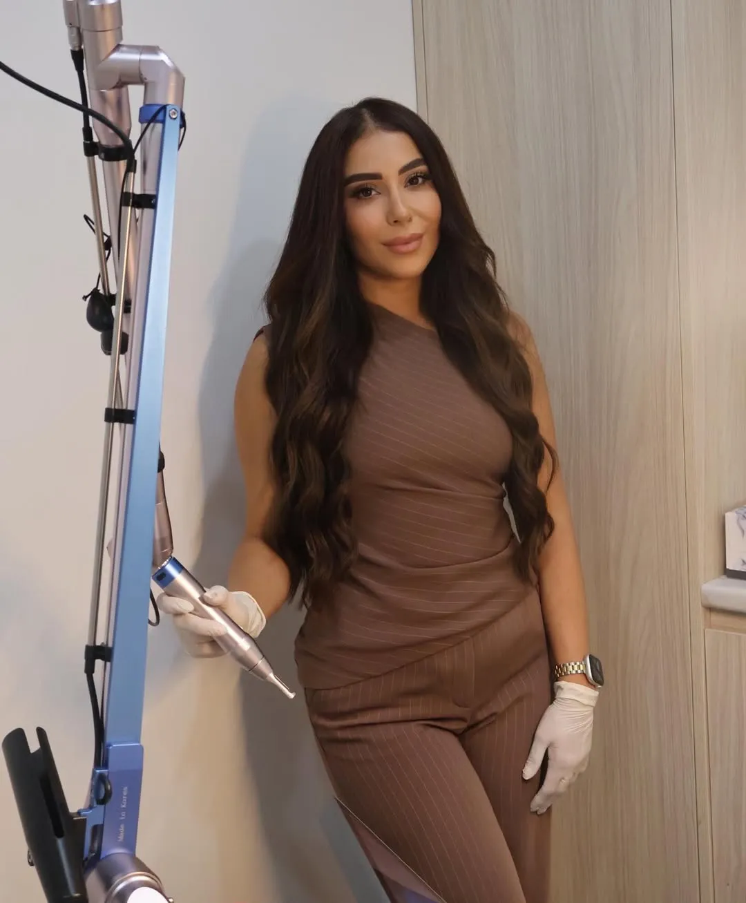 May, lead practitioner at Beauty Atelier with laser equipment